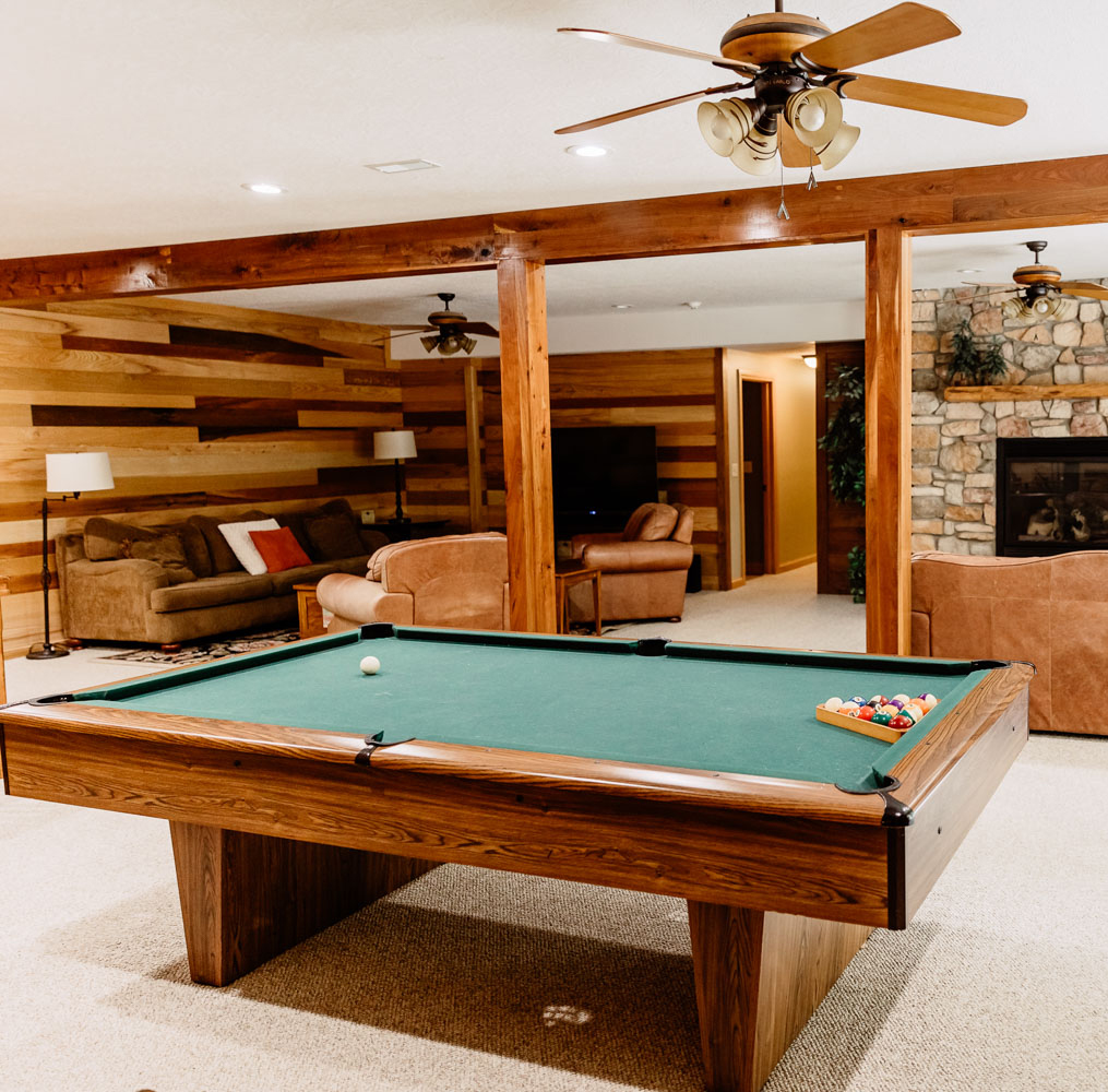 Game room with a pool table and cozy seating area