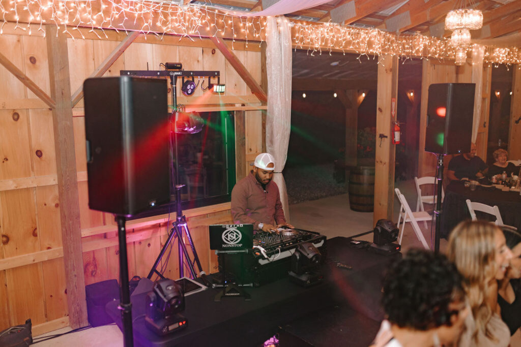 DJ setting up music equipment at a wedding reception in Montgomery Creek Ranch