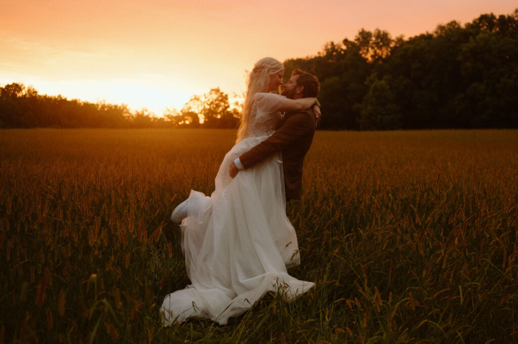 Bride and groom embracing in a field at sunset at Montgomery Creek Ranch