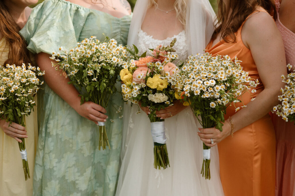 Close-up of bridal bouquets featuring colorful flowers and greenery