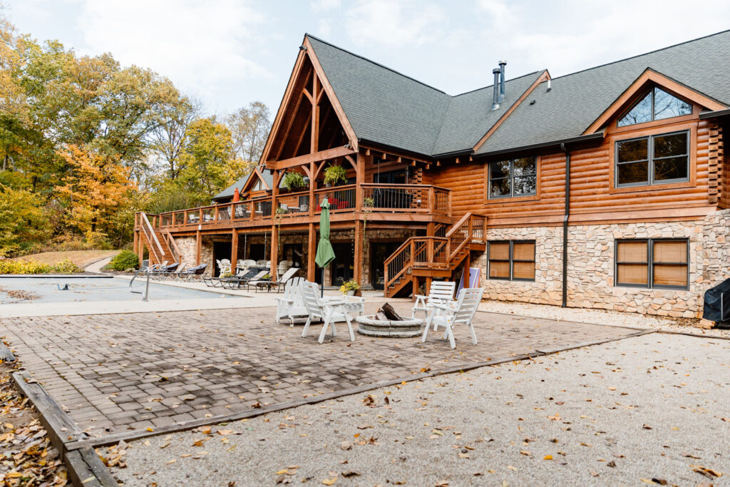 Large wooden lodge with spacious patio and seating areas