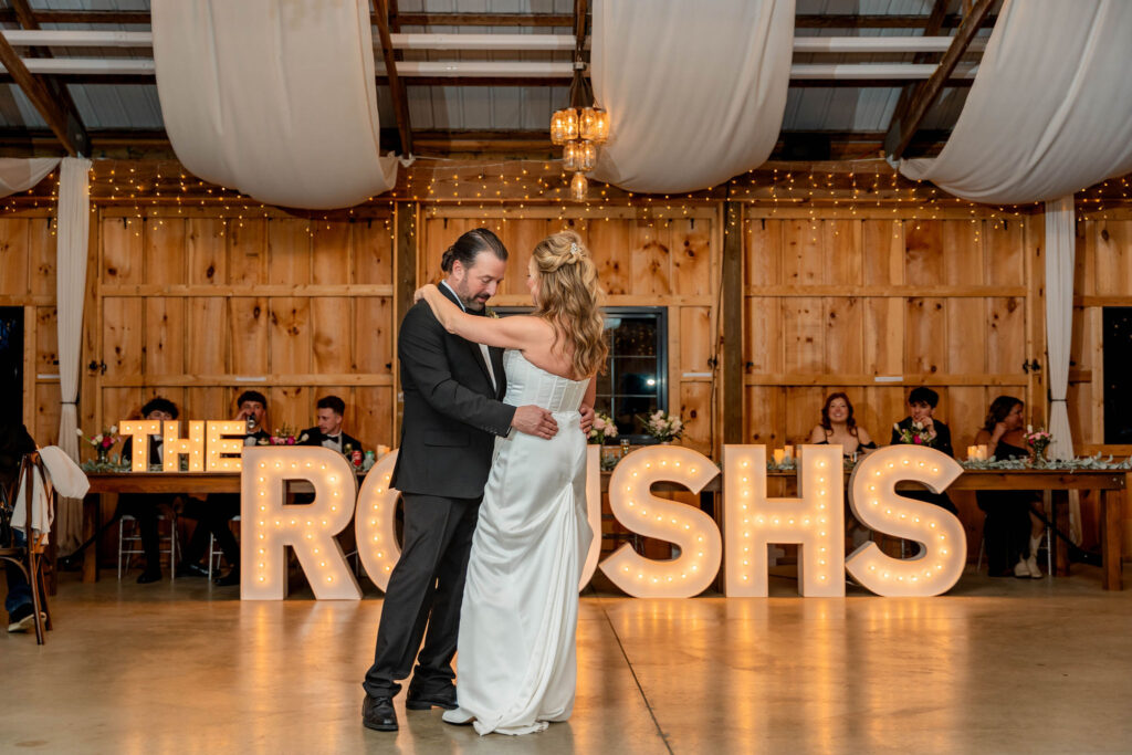 Bride and groom first dance inside a budget wedding venue