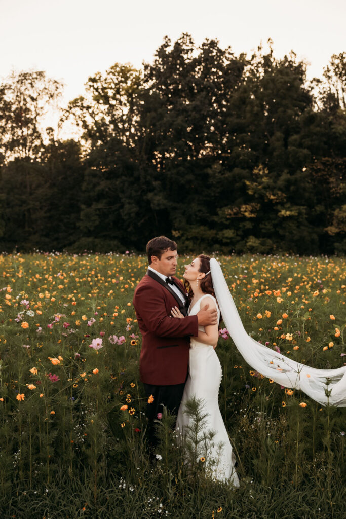 Romantic wedding portrait in a flower field at a budget wedding venue