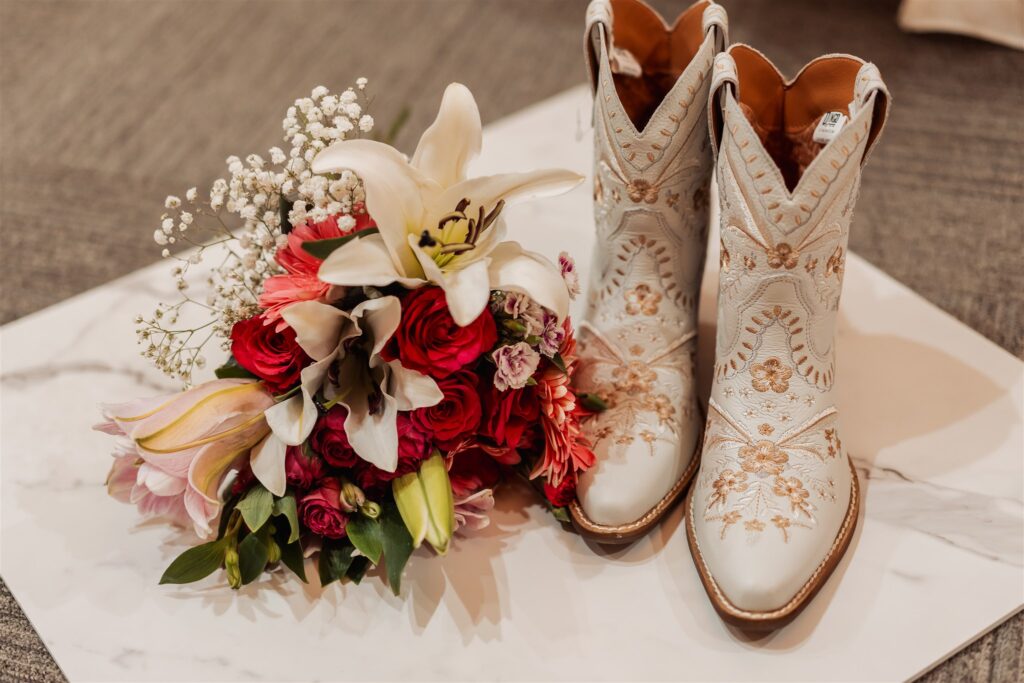 Bridal boots and bouquet are styled together as part of wedding planning 6 months out
