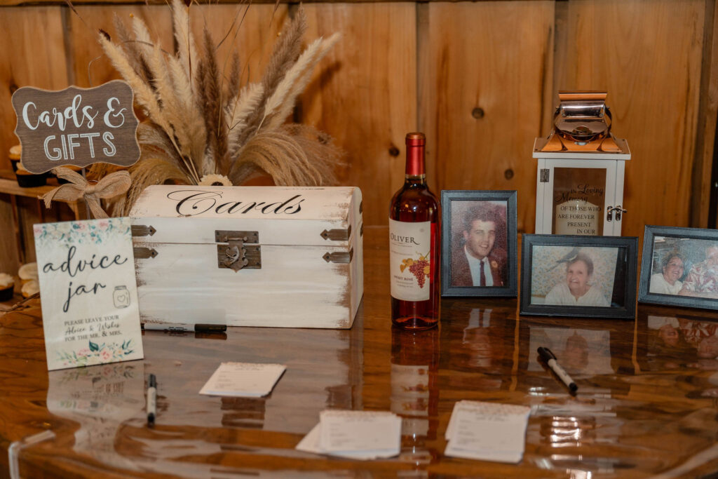 Wedding cards and gifts table with framed memorial photos