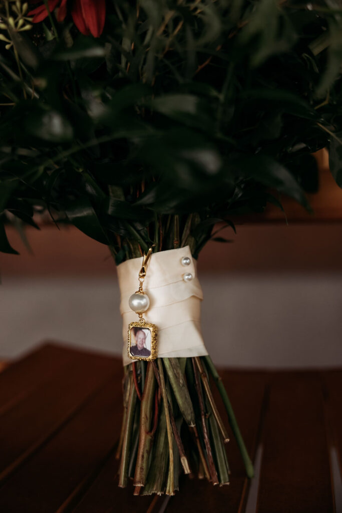 Close-up of memorial photo charm on wedding bouquet