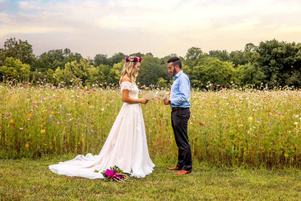 Couple exchanging vows in a wildflower meadow