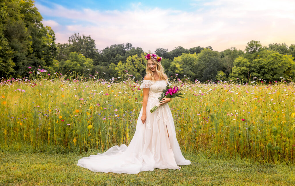 Bride holding bouquet in a vibrant wildflower meadow