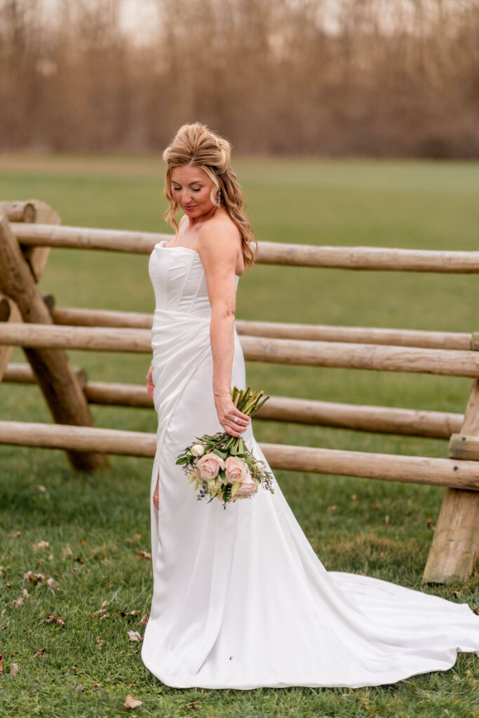 Bride portrait by fence