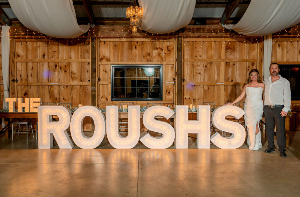 Couple posing with large marquee letters